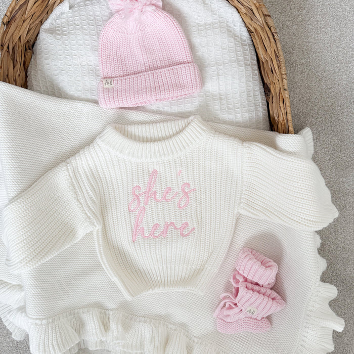 White chunky knitted jumper with pink script logo, ribbed crew neck, ruffled sleeves