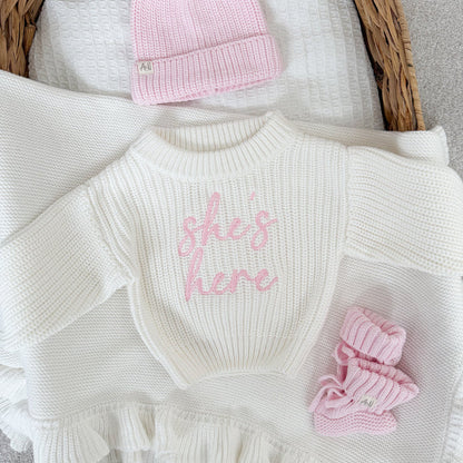 White chunky knit jumper with pink logo, ribbed neckline, ruffled hem and cuffs
