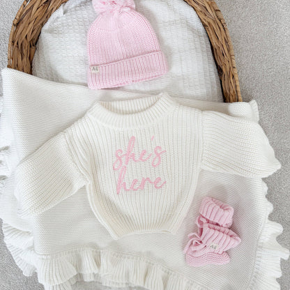 White chunky knitted jumper with pink script logo, ribbed crew neck, ruffled sleeve ends