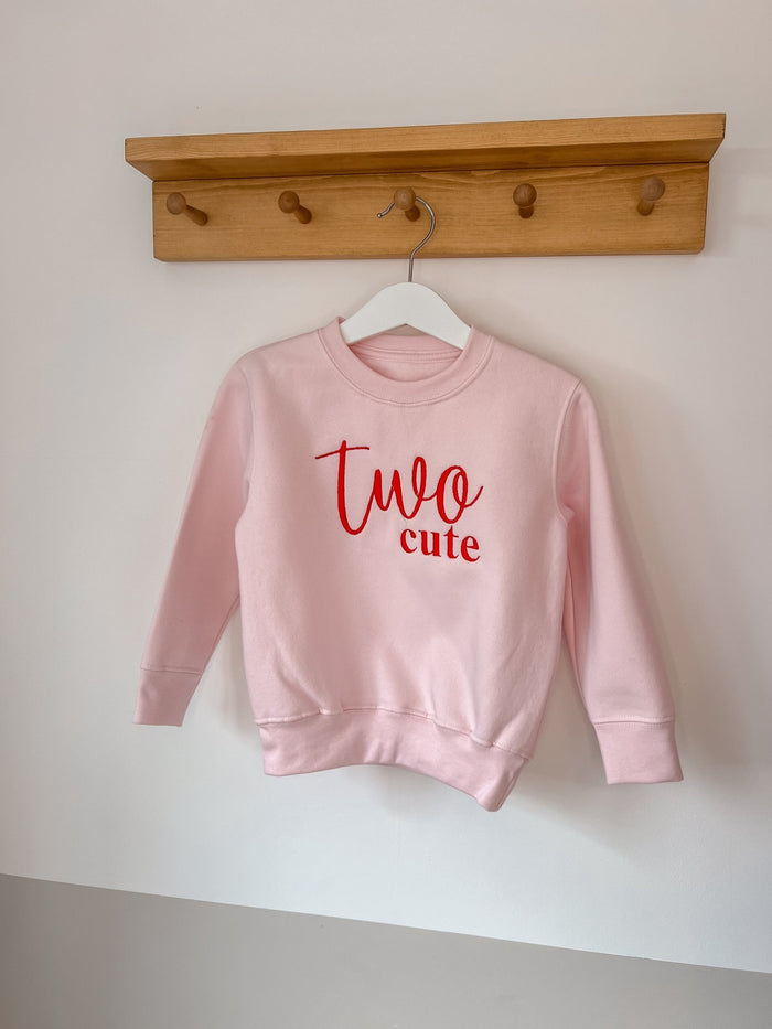 Pink kids sweatshirt with red 'Two cute' logo print and long sleeves
