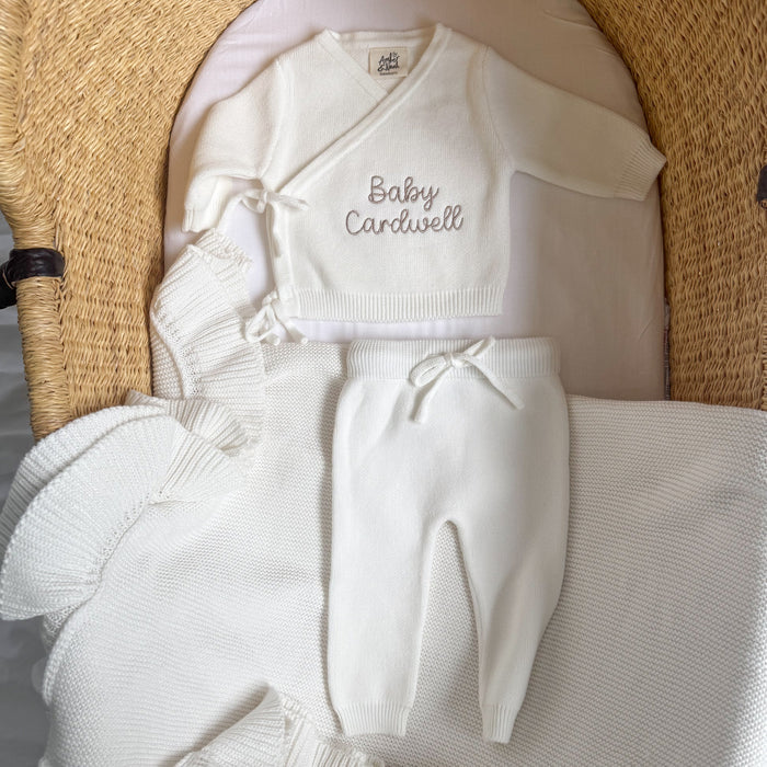 White baby kimono set: 'Baby Cardwell' knit top, pants, socks, and hat