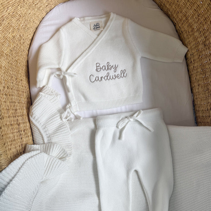 White baby kimono set with 'Baby Cardwell' knit top and tied pants, plus socks