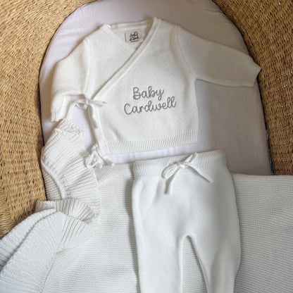 White baby kimono set with 'Baby Cardwell' knit top and tied pants, plus socks