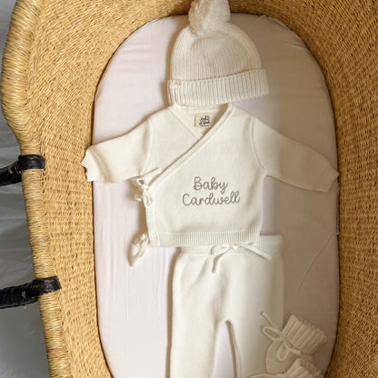 White baby kimono set with 'Baby Cardwell' knit top, pants, and white beanie hat