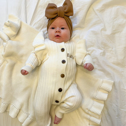 White knit romper with frill sleeves, button front, and brown bow headtie