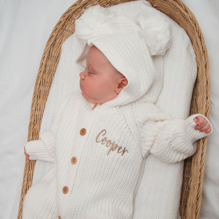 White knit baby romper with hood, long sleeves, and button front with name embroidery