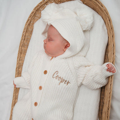 White knit baby romper with hood, long sleeves, and button front with name embroidery