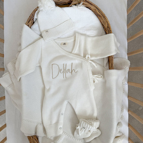 White long romper with Delilah name embroidery and buttoned leg openings