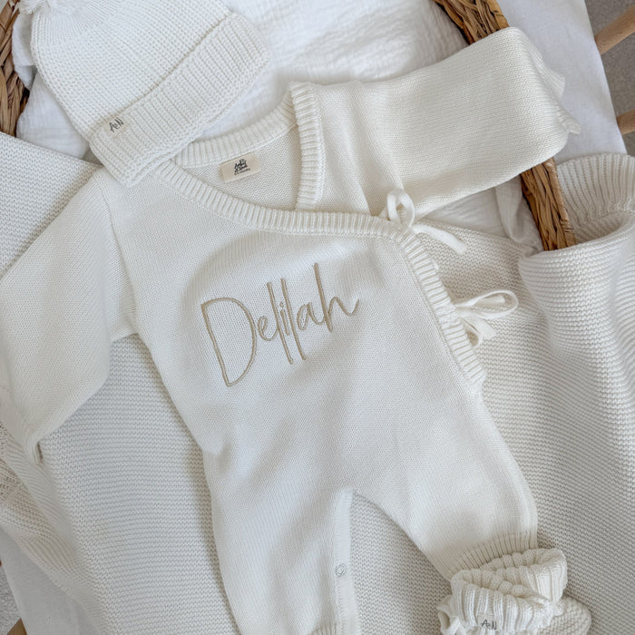 White long romper with Delilah name on the chest and ribbon-tie neckline