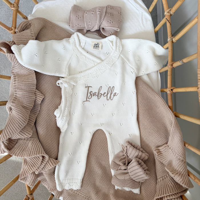 White pointelle kimono romper with ruffled edges and embroidered “Isabella” on the front.