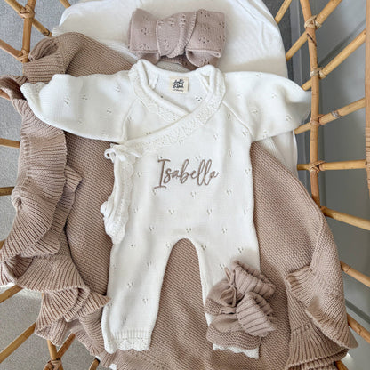 White pointelle kimono romper with ruffled edges and embroidered “Isabella” on the front.