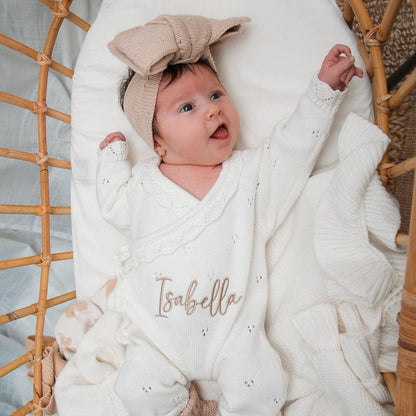White pointelle kimono romper with embroidered “Isabella” across the chest and snap leg opening.